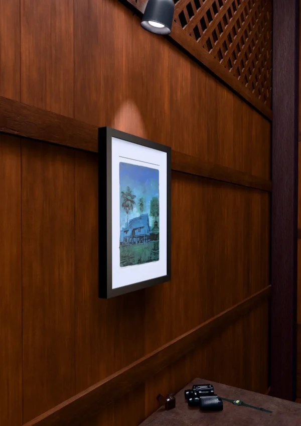 Frame 526 in Winter, gel plate monotype by Daniel Arendzen, framed on a wooden wall under a spotlight, seen from the side, with binoculars, a watch and a lighter on a table below. The room is a Blender render of the interior of the same traditional Malaysian house shown in the print.