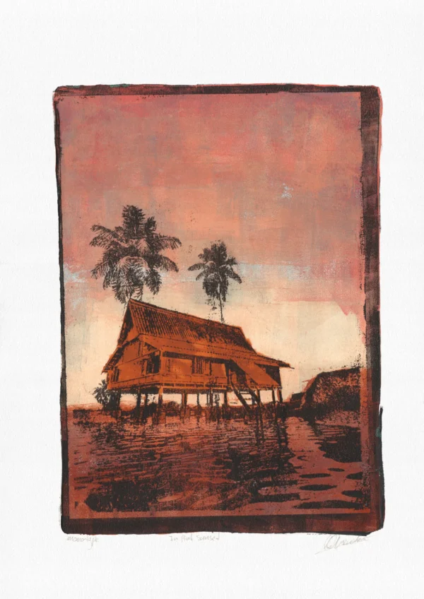 In Pink Sunset, gel plate monotype by Daniel Arendzen, shown in full including the paper and the pencil writing at the bottom. The impression shows a traditional Malaysian house in orange-brown with two palms, under a pink sunset sky, reflected in rust-coloured water, on textured cold-pressed paper