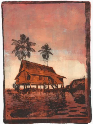 In Pink Sunset, gel plate monotype by Daniel Arendzen, showing the printed image only: a traditional Malaysian house on stilts in orange-brown with two dark palms, under a pink sunset sky that turns pale near the horizon, reflected in rust-coloured water, inside a dark edge