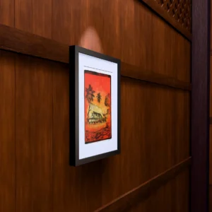 Red Water, gel plate monotype by Daniel Arendzen, framed on a wooden wall under a spotlight, seen from the side, with binoculars, a watch and a lighter on a table below. The room is a Blender render of the interior of the same traditional Malaysian house shown in the print.